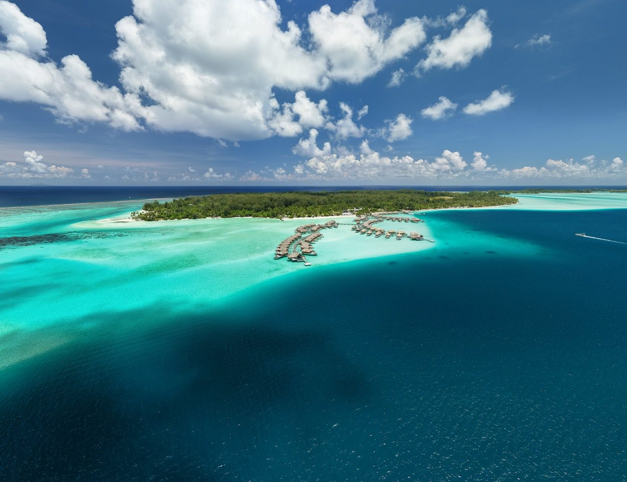 Aerial view of Le Bora Bora by Pearl Resorts and its overwater bungalows in Bora Bora